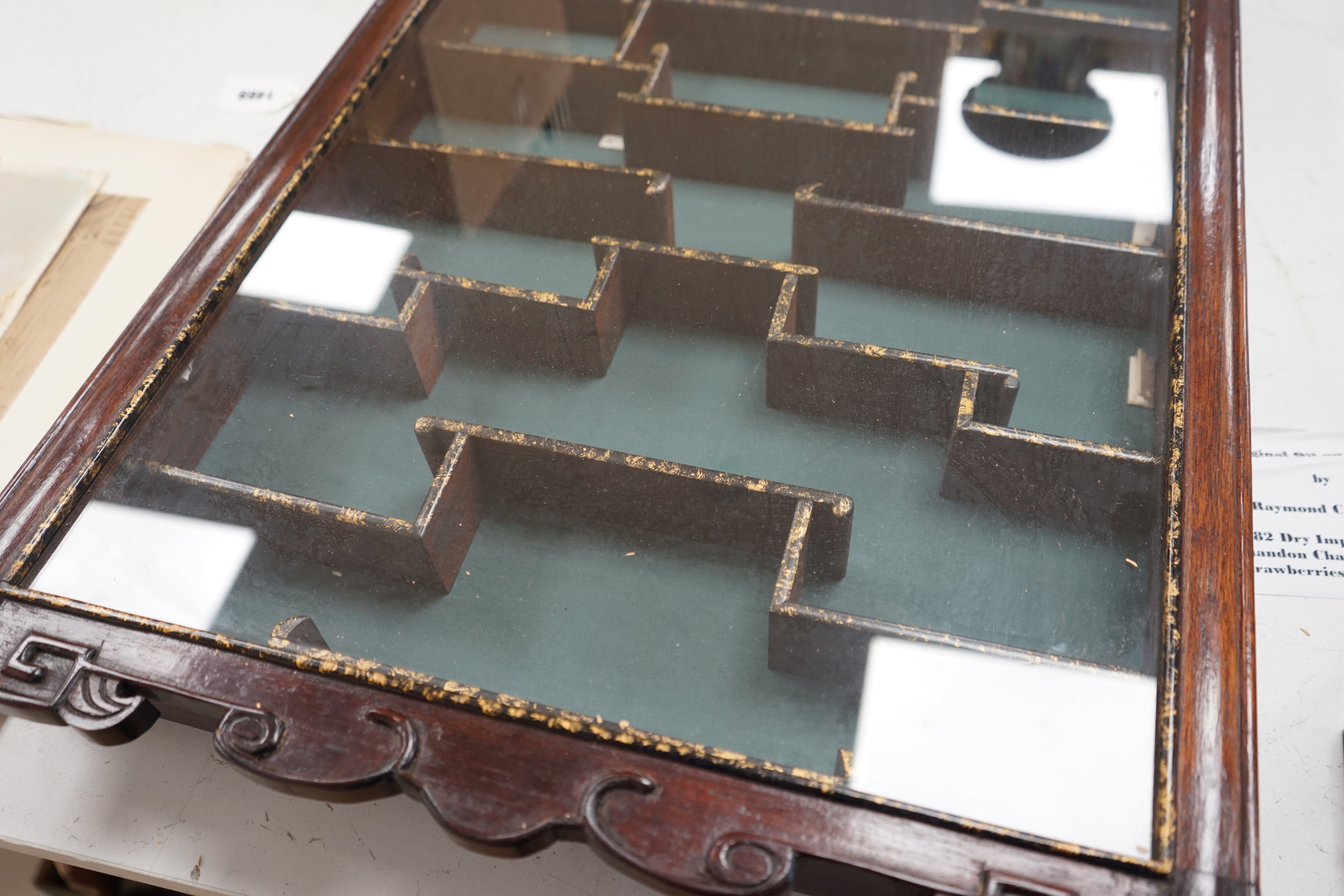 A Chinese hardwood snuff bottle cabinet with glazed front, gilded decoration and key, 84cm high